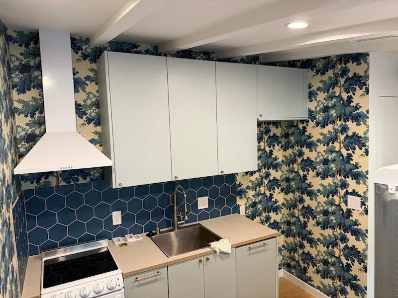 Lake house kitchen with botanical wallpaper installed near Canyon Lake