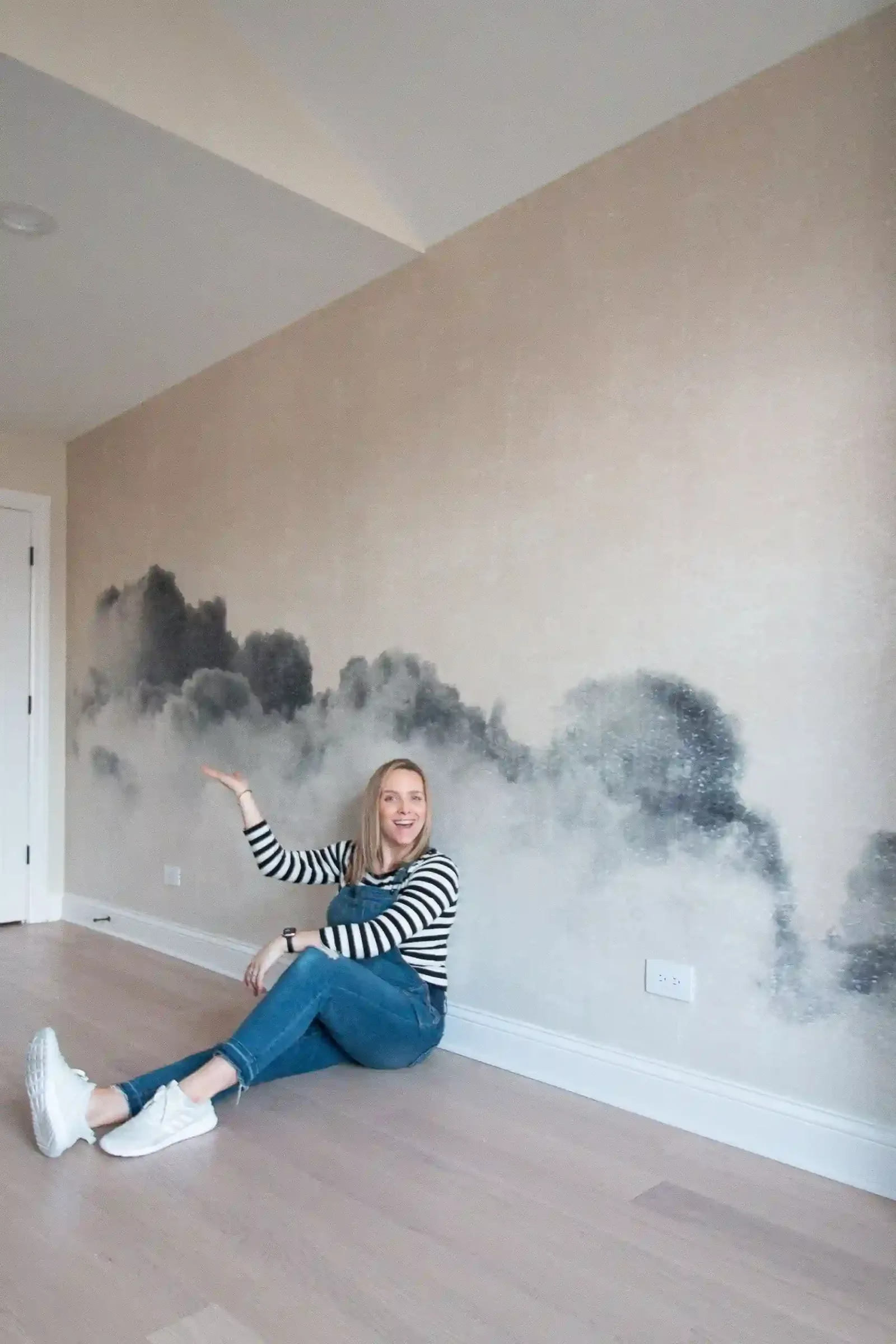 Happy homeowner relaxing beside a newly installed mural wall in San Antonio