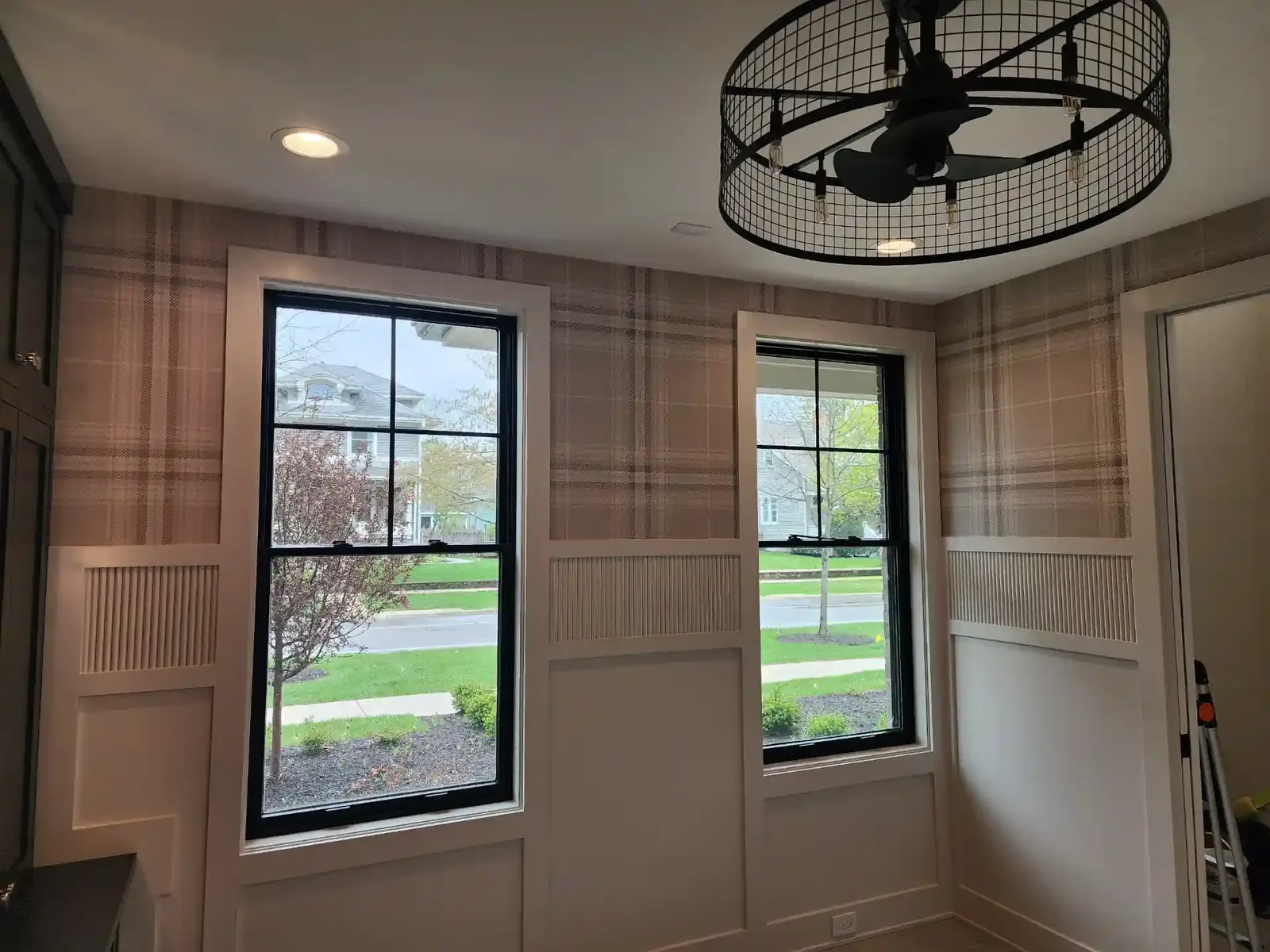 Historic wood-paneled room prepared for period wallpaper installation